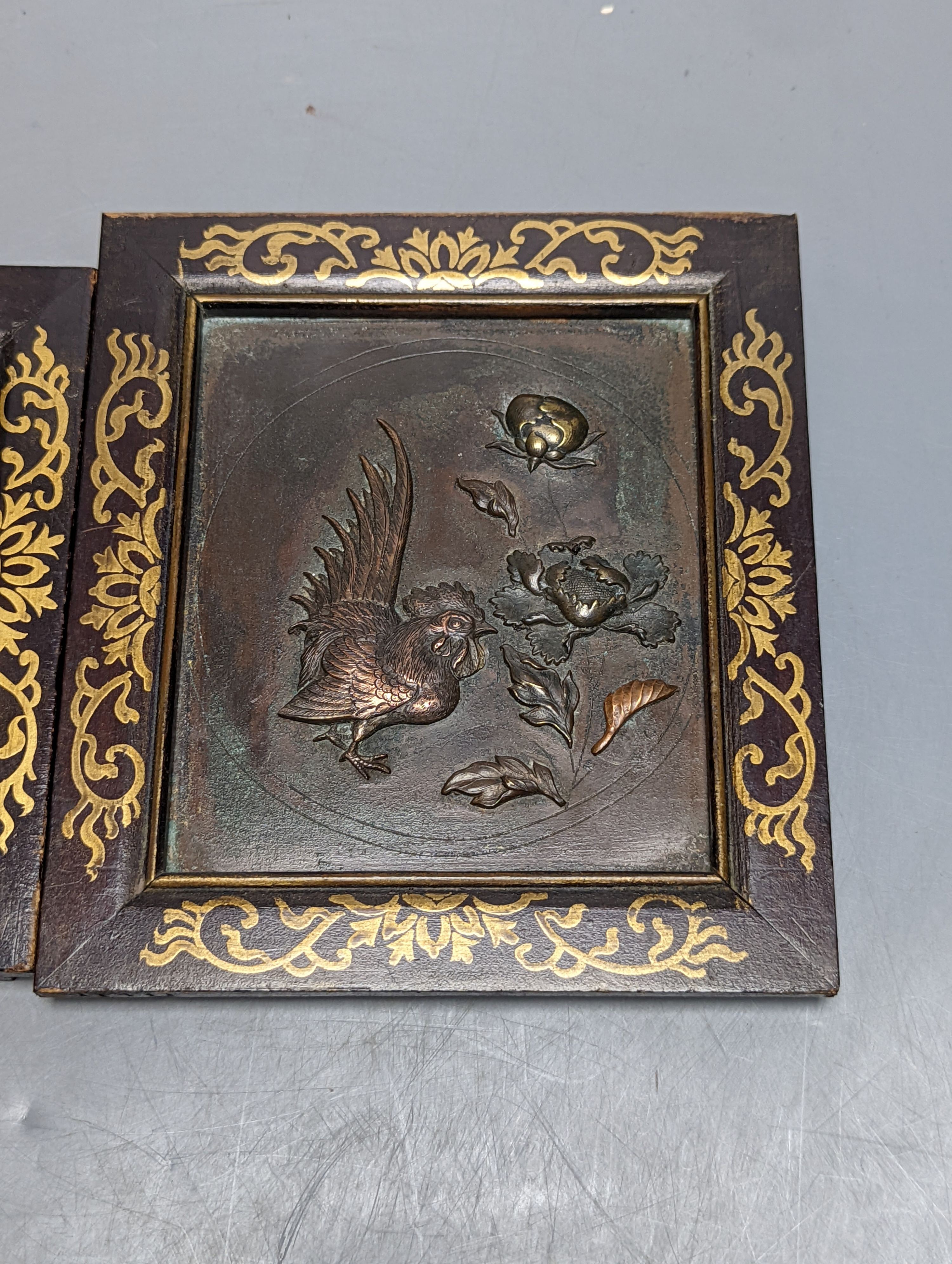 A pair of Japanese mixed metal chicken panels, in gilded wood frames, 17cm. high